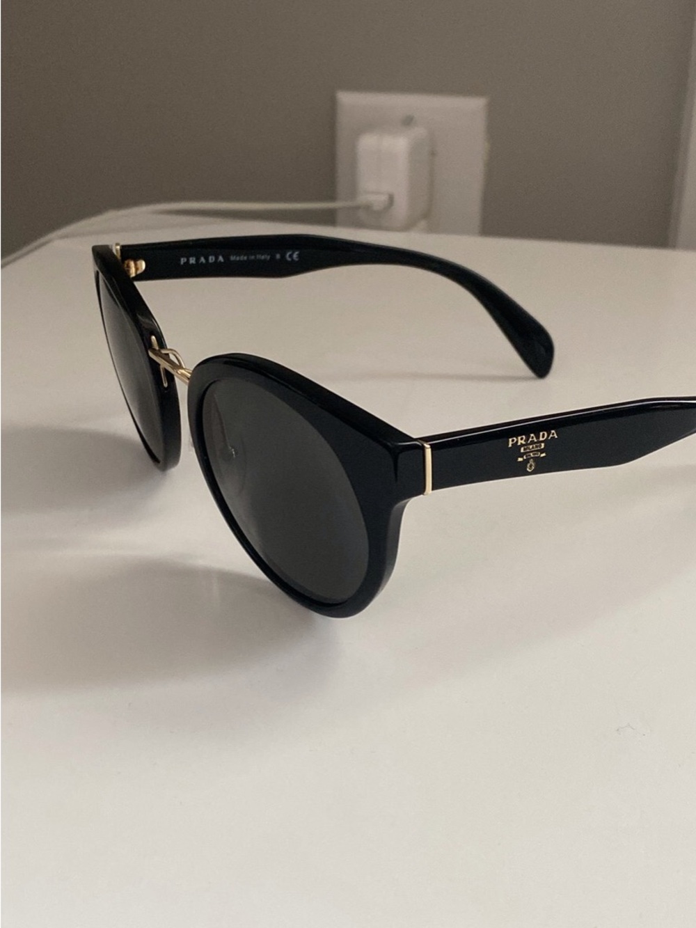 Prada Black Round Sunglasses with Gold Detailing